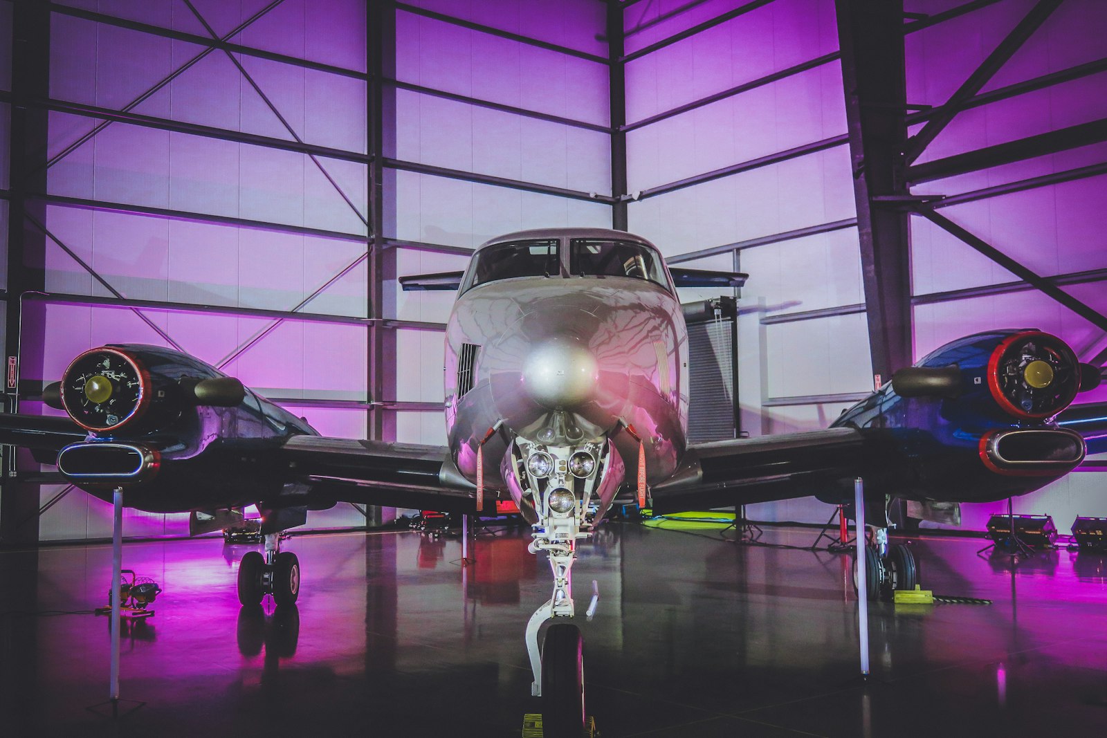 White private jet parked inside a hangar